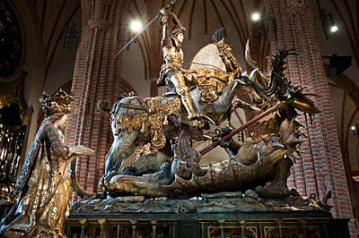 St Göran och draken. Allegorisk staty från 1400-talet. Riddaren symboliserar Sten Sture dä. som besegrar den hemska draken Danmark och försvarar kvinnan, Sverige.